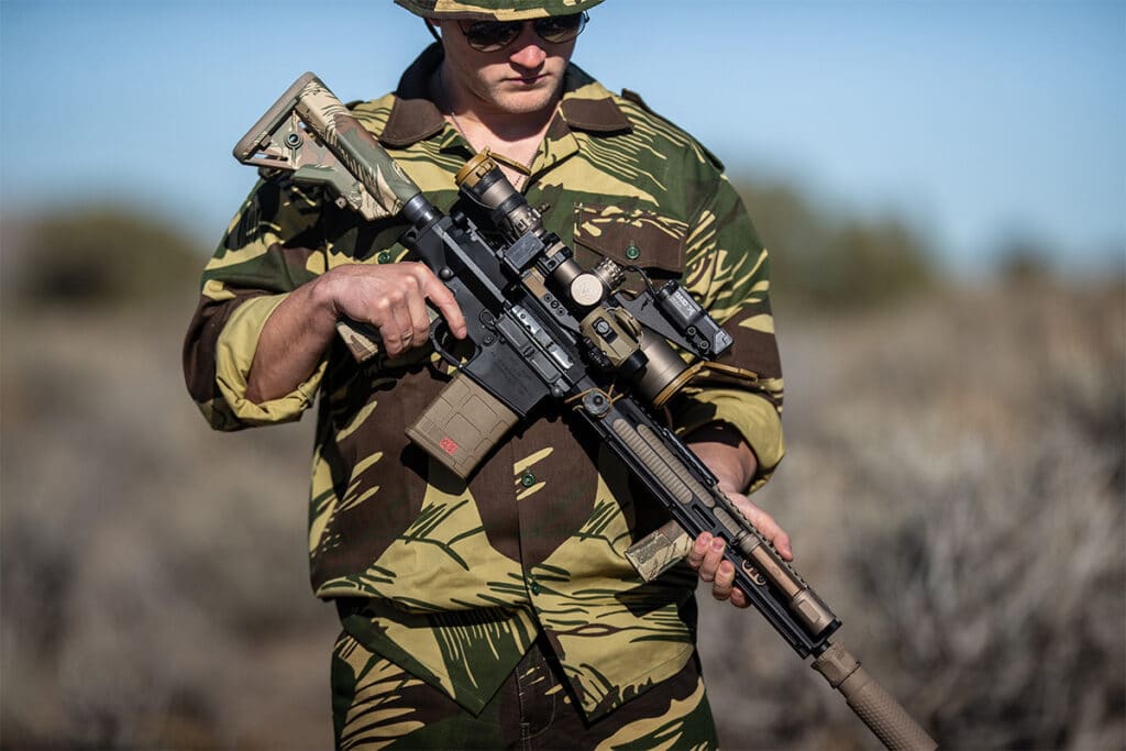 Operator Holding Rifle Dipped in Rhodesian Brushstroke Camo